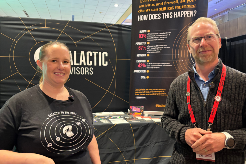 Nathan Whittacre of Stimulus Technologies and Allison Tegeler from Galactic Advisors pose at a cybersecurity vendor booth at the TMT IT Sales and Marketing Boot Camp.